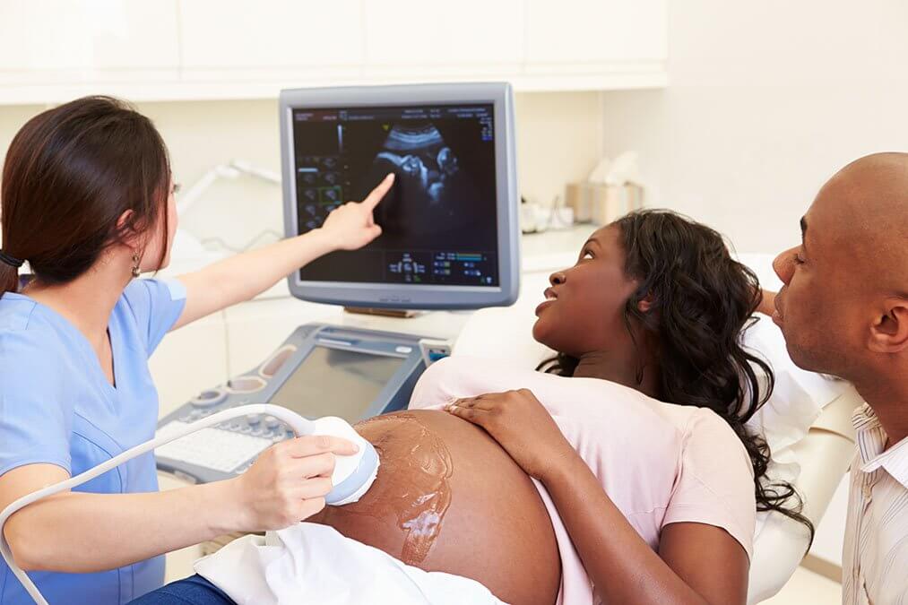 Mum getting and ultrasound and being shown the baby